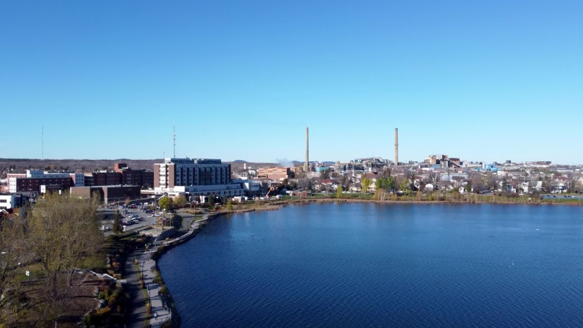 Aerial view of Rouyn-Noranda City foundry factory and Osisko Lake in a fall season sunny day. Abitibi-Temiscamingue, Quebec, Canada.
