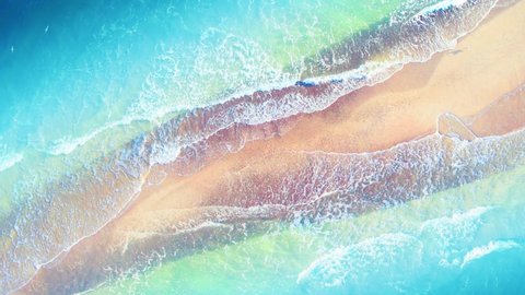 Aerial view at sunrise over the sea. Beautiful sea waves. Pink yellow sand and amazing sea. Arkivvideo