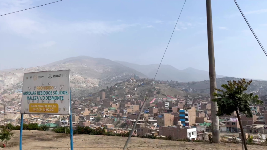 Poor slum city over mountain range at Manchay, Lima, Peru. Shot from a moving car Royalty-Free Stock Footage #1092982633