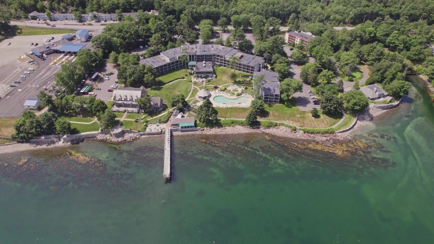Aerial view of hotel and resort with pool and pier on the east coast by the Atlantic Ocean shoreline