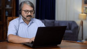 An Indian businessman on an online business video call - office meeting, remote work, foreign client meeting . A middle-aged man in his late forties working from home - distant communication, remot...