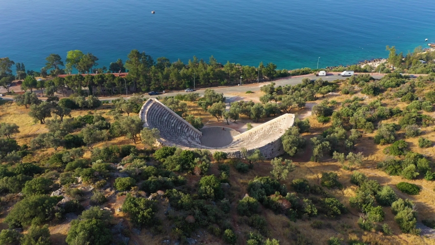 Kas Hellenistic Theatre and Green Trees. Antalya, Turkey. Aerial Vertical Top-Down View. Drone Flies Forward, Tilt Down