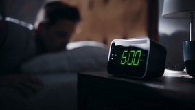 Man Wakes Up, Turns off Alarm Clock with Frustration. Early Rising Productive Man Ready Start a Day full of New Problems. Focus on the Clock Showing Six A.M. Bedside Nightstand Bedrooom Apartment - Powered by Shutterstock - Get 15% off with code: PIKWIZARD15