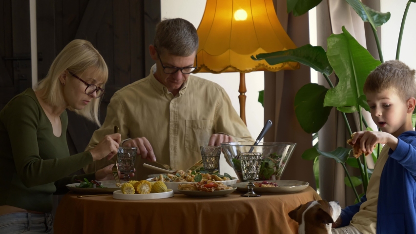 family having dinner at the table indoor at home