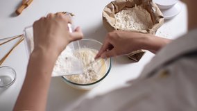 Girl hostess cook mom cooking liquid dough for fritters pancakes pancakes delicious breakfast for children, flour falls pours from a ladle measuring utensils, the process of making batter
 - Powered by Shutterstock - Get 15% off with code: PIKWIZARD15