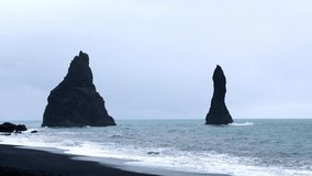 Majestic place of the stormy Atlantic ocean. Basalt rocks - Troll toes. Reynisfjara Beach in Iceland, Europe. Scenic video of popular European travel destination. Beautiful nature in Iceland.