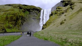 Majestic nature of Iceland. Impressively View on Skogafoss waterfall. Skogafoss the most famous place of Iceland with rainbow. Beautiful 4k video.