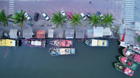Top down view of fisher boats at port dock at coast city of Itanhaem, state of Sao Paulo, Brazil. Nautical vessel fishing boat at Itanhaem Sao Paulo Brazil. Top view of pier dock port. Boats at pier.