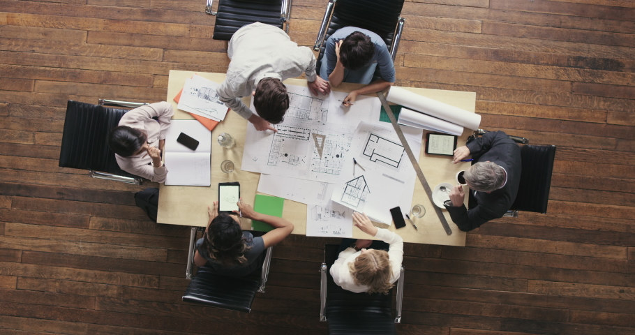 Architect, engineer and diverse team discussing, talking and planning while analyzing blueprints for a project from above. Teamwork, collaboration and group of executives choosing and brainstorming | Shutterstock HD Video #1093000255