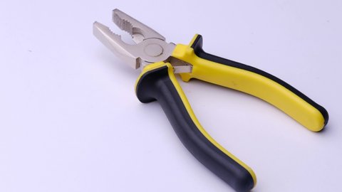 Pliers close-up on a white background, video tools.
