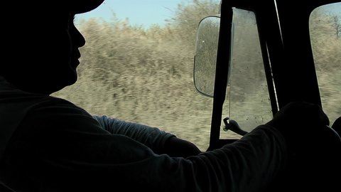 Santiago del Estero, Argentina - March 2020: Silhouette of a Man Driving an Old Pickup Truck. Close-Up.