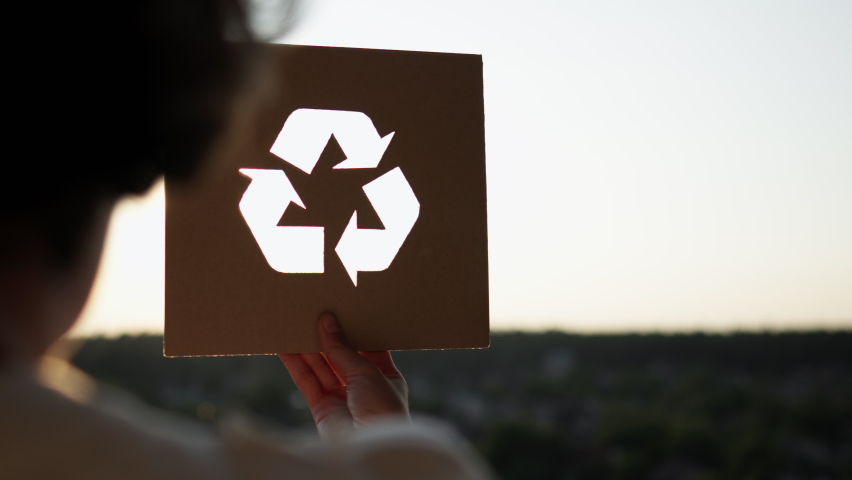 Product reuse sorting waste products, Girl holding a recycling sign reuse products, Arrow symbol sign recycling saving environment. Active girl campaigns to save the earth
 Royalty-Free Stock Footage #1093018679