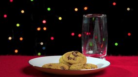 Pouring a glass of milk and a serving of cookies for Santa on Christmas Eve.