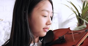 girl playing violin at home, Kid play songs portrait, Home lessons with music, Activities for children at home, Video chat conference lesson and online music tuition, Classical education Music concept