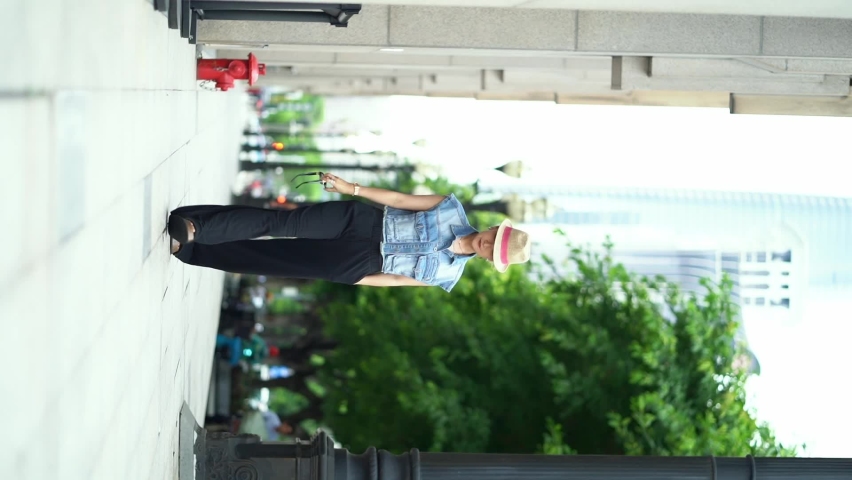 Asian beauty walking on street wearing hat and jeans | Shutterstock HD Video #1093035929