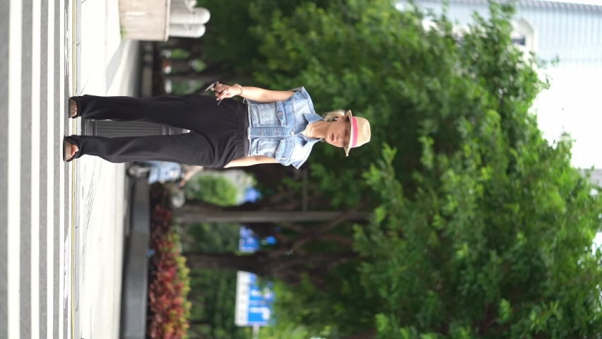 Asian beauty walking on street wearing hat and jeans | Shutterstock HD Video #1093035931