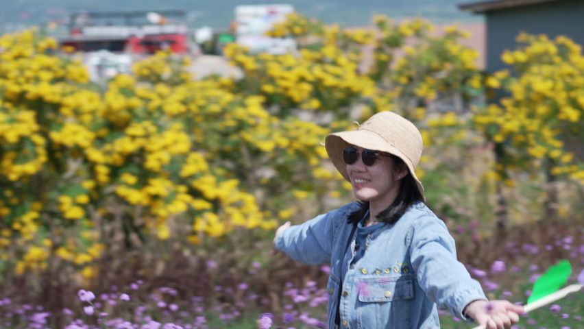 Asian Woman Walking in Flowers Garden in Summer Vacation
