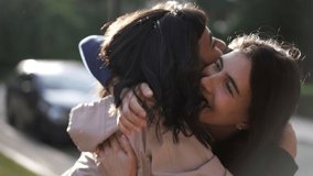 Two happy female best friends hugging each other. Women embrace reunion outdoors at park - Powered by Shutterstock - Get 15% off with code: PIKWIZARD15