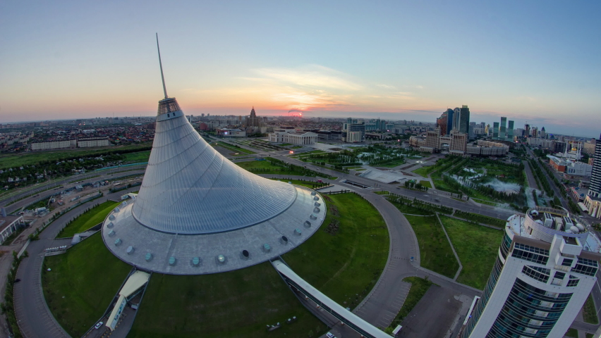 Elevated view with sunrise over the city center with Khan Shatyr and central business district transition aerial timelapse before sunrise time from rooftop, Kazakhstan, Astana, Central Asia Royalty-Free Stock Footage #1093048043