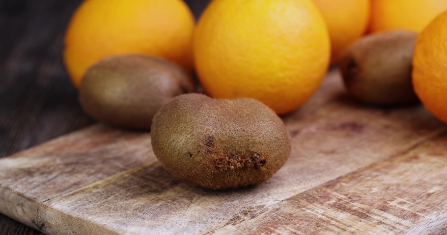 cut into pieces ripe green kiwi, cut into slices of fresh green kiwi on a cutting board during cooking