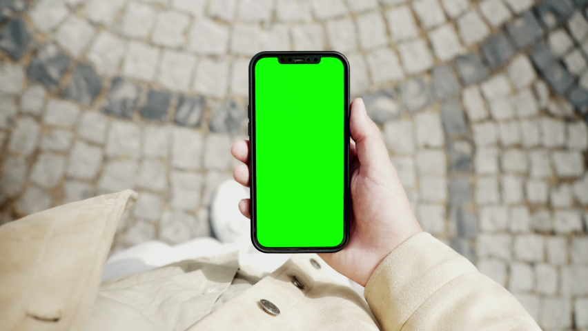Young Man Phone Look and Busy Walking to Work Close-up. Caucasian Guy Hold in Hand Smart Phone with Green Screen Mock-up. Urban Life Leisure in Blank Smartphone. Cellphone for Footage, App, Copy Space Royalty-Free Stock Footage #1093065197