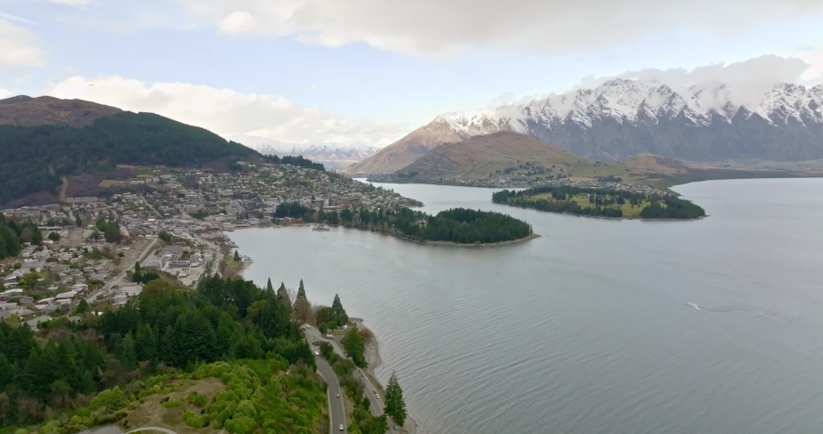 Aerial view of lake, town and mountain in Queenstown, New Zealand. Royalty-Free Stock Footage #1093065569