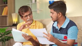 Grandfather with son discussing about education or property documents at home - concept of Medical insurance, financial debt and Mortgage - Powered by Shutterstock - Get 15% off with code: PIKWIZARD15