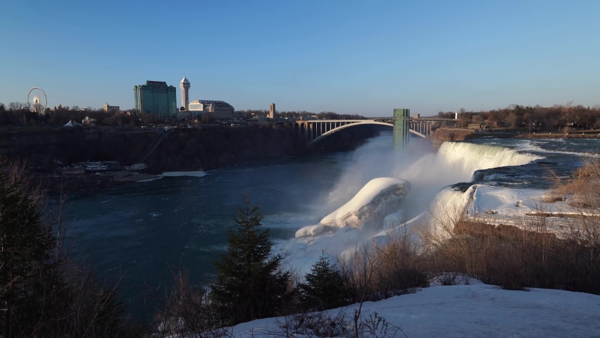 Niagara Falls And Rainbow International Bridge Across The Niagara River Gorge In Ontario, Canada. - wide