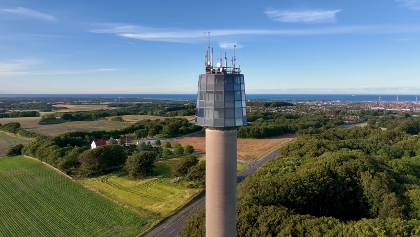 An aerial view of a observation tower on a sunny summer evening.