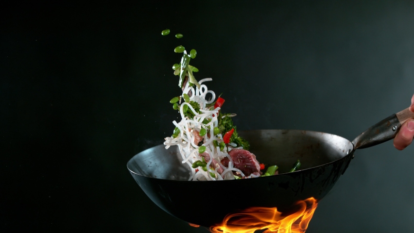 Super Slow Motion of Flying Asian Beef Meat with Vegetable and Noodles. Filmed on High Speed Cinema Camera, 1000 fps. 