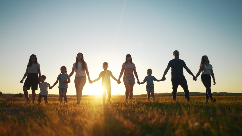 Community large family in the park. a large group of people lifestyle holding hands walking silhouette on nature sunset in the park. big family kid dream concept. people in the park. large family | Shutterstock HD Video #1093074865