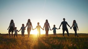 community large family in the park. a large group of people lifestyle holding hands walking silhouette on nature sunset in the park. big family kid dream concept. people in the park. large family - Powered by Shutterstock - Get 15% off with code: PIKWIZARD15