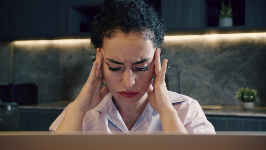 Stressed young european woman suffering from muscles tension, having painful head feelings due to computer overwork or sedentary working lifestyle. Tired employee overwhelmed with tasks in office. Royalty-Free Stock Footage #1093075057