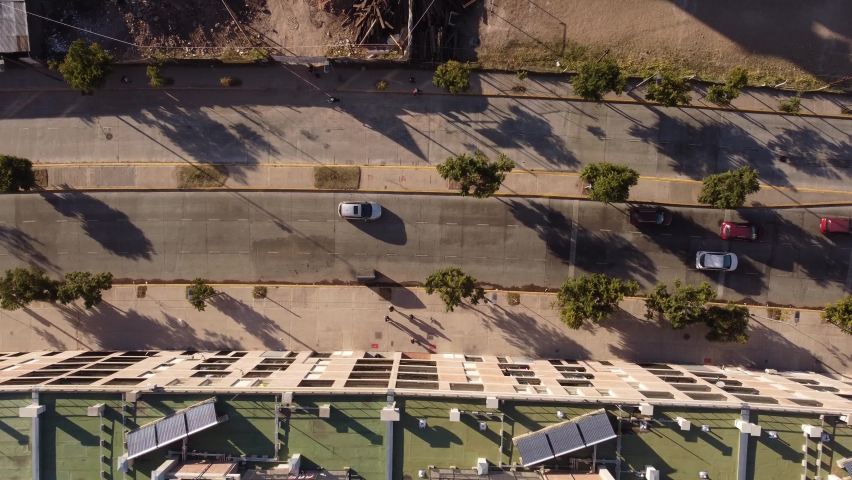 Cars driving and people walking at Chacarita Area in Buenos Aires city in Argentina. Aerial top down view