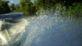 Slow motion video of water splashing from a boat.