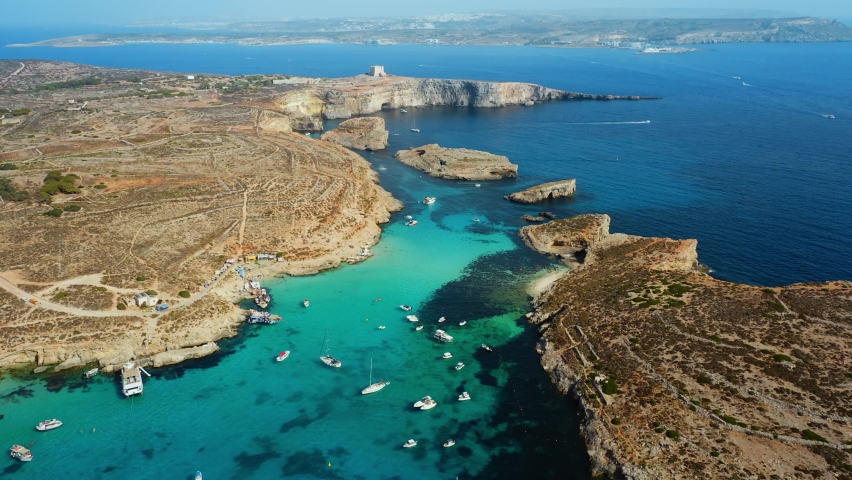 Aerial top view of Comino island, part of Malta. Blue lagoon, summer, boats, blue sea | Shutterstock HD Video #1093082731