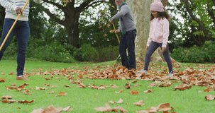 Video of happy african american father and daughter collecting leaves with grandfather in garden. Family, domestic life and togetherness concept digitally generated video.