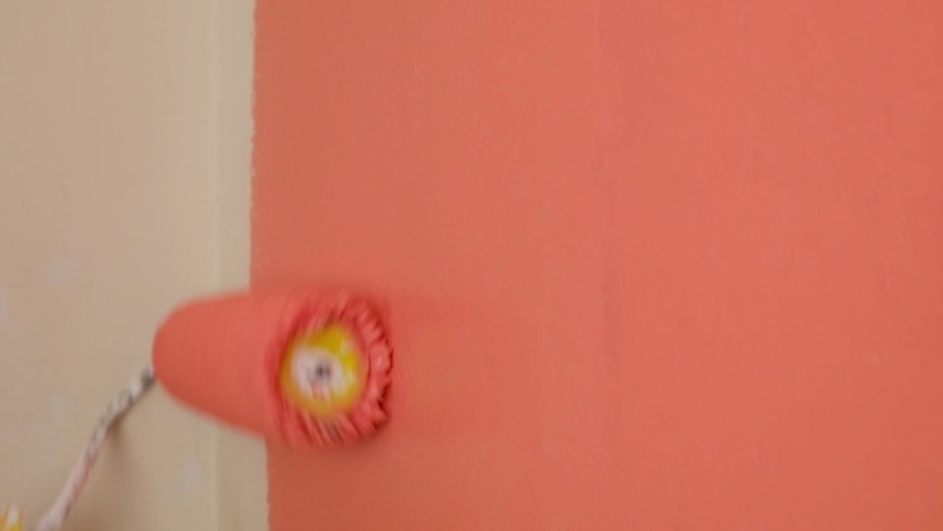paint the walls in peach color with a roller, refurbishment in the room High quality FullHD footage