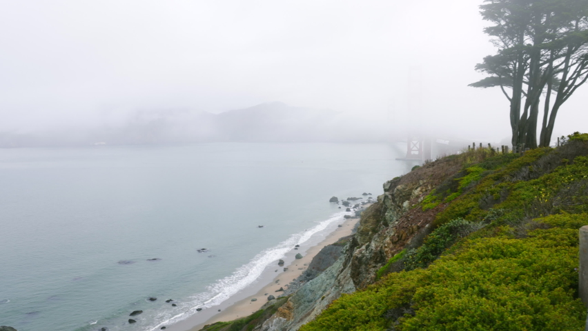 Panoramic view of Golden gate bridge and Marshals beach covered in fog from vista point | Shutterstock HD Video #1093095867