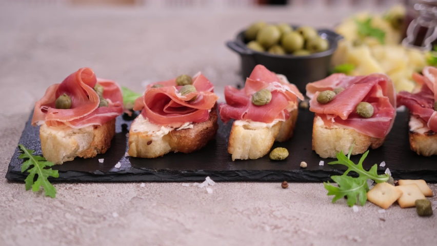 bruschetta with prosciutto or jamon ham and cream cheese on stone serving board Royalty-Free Stock Footage #1093096613