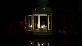 A candle burning at night in a decorative candlestick with red flowers. Decorative floating candle burning at night on a glass table. The concept of a romantic evening, love. - Powered by Shutterstock - Get 15% off with code: PIKWIZARD15