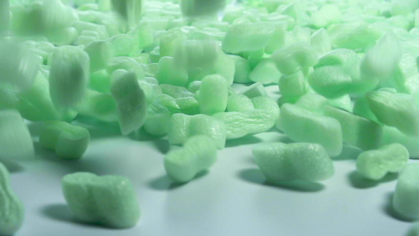 Green Storyfoam Packing peanuts being poured falling into cardboard box, care shipping products for customers by protective granules . Online shopping retailer. | Shutterstock HD Video #1093104603