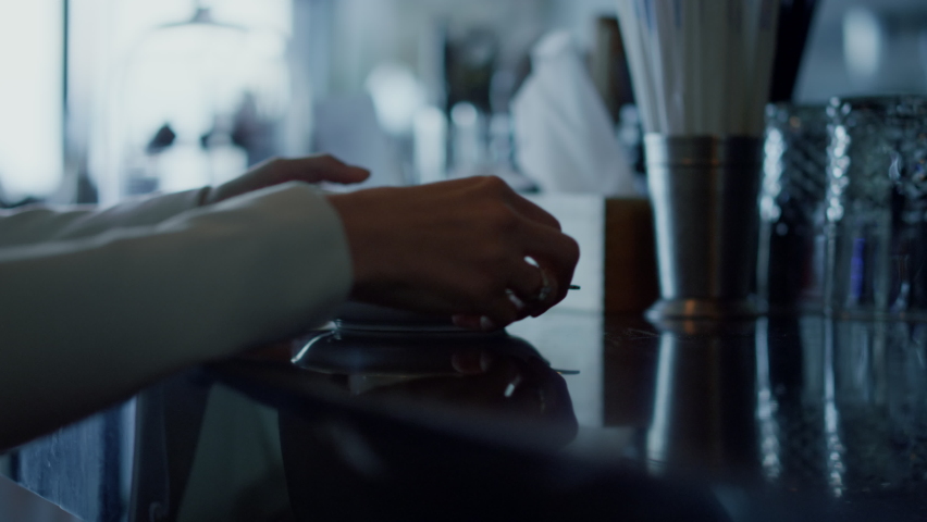 Businesswoman hands holding coffee cup closeup. Relaxed woman silhouette enjoy beverage at dark cafe. Unrecognizable employee tasting hot espresso resting at restaurant. Manager at work break