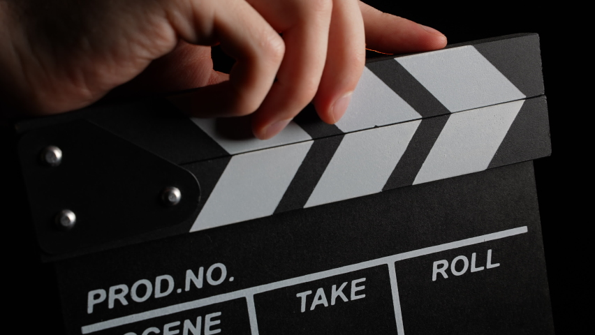 Clapperboard Shuts to Start Shooting Movie Film. Movie Clapper Board on Black Background. Clapperboard Clapper for Video and Audio Sync. Movie Filming Device. Film Production Process. Behind the Scene Royalty-Free Stock Footage #1093107677