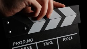 Clapperboard Shuts to Start Shooting Movie Film. Movie Clapper Board on Black Background. Clapperboard Clapper for Video and Audio Sync. Movie Filming Device. Film Production Process. Behind the Scene