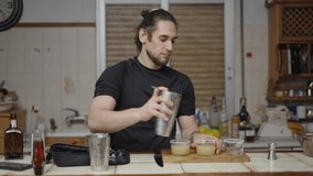 Proud bartender shows final result of cocktail in a video tutorial for his channel 