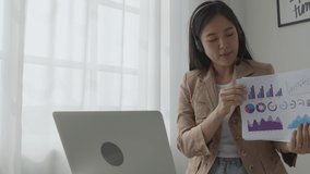 Young asian business woman using laptop computer for video conference online, businesswoman working with video call for meeting and showing graph report for finance, communication concept. - Powered by Shutterstock - Get 15% off with code: PIKWIZARD15