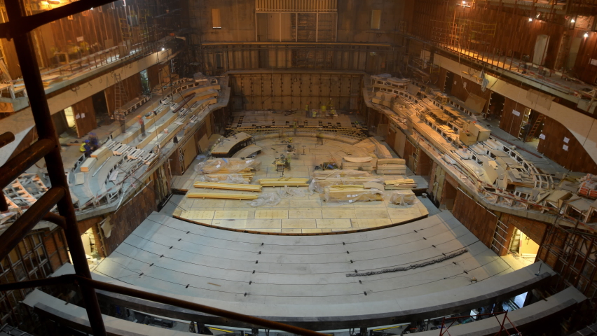 Timelapse of equipment and spectator seats installing in spacious concert hall for week. Theater with digital screen and audience with levels. Entertainment center