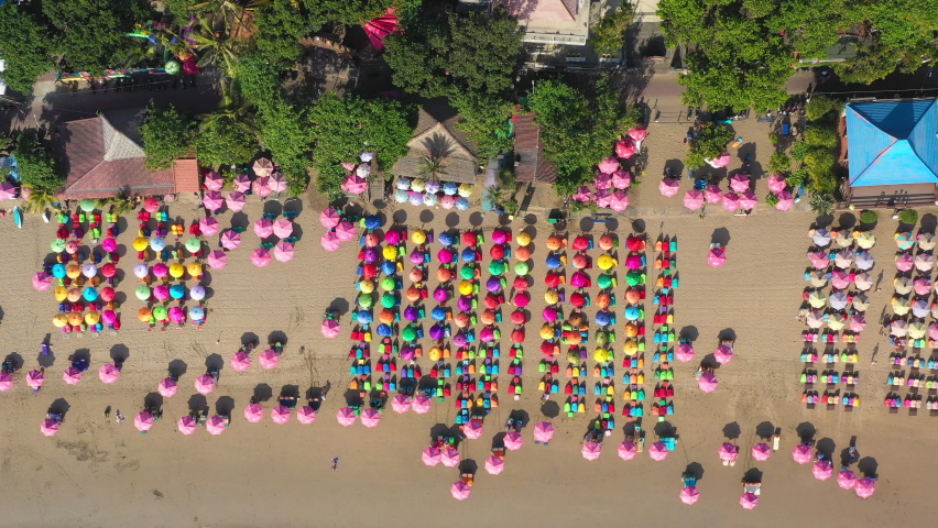 Aerial Directly Over A Crowded Tropical Bali Beach With Brightly Colored Umbrellas - Kuta, Indonesia Royalty-Free Stock Footage #1093113669
