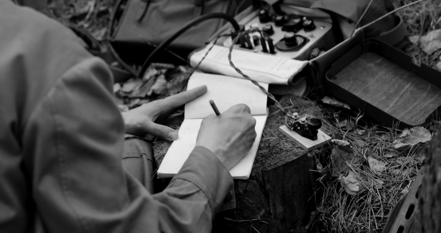 Russian Soviet Infantry Red Army Soldier In World War II using Russian Soviet Portable Radio Transceiver In Trench Entrenchment In Spring Autumn Forest. 4K. Headphones And Telegraph Key. Close Up